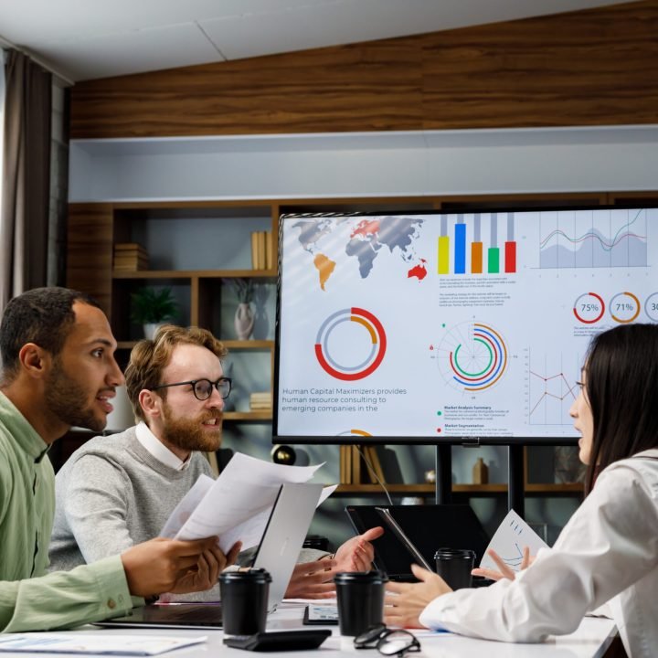 A team of young mixed race businessmen working on a startup. Business strategy, teamwork. Financial crisis. Failed startup. Communication network. multinational professional team