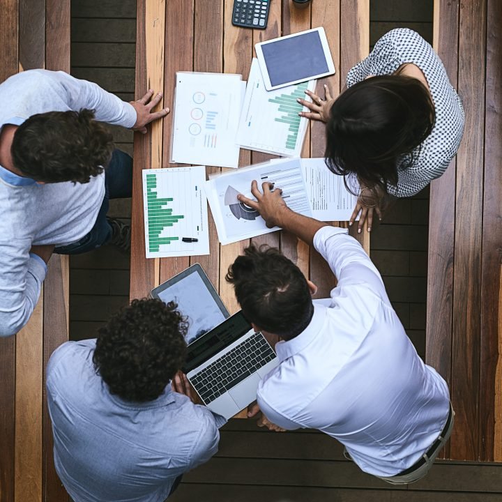 High angle shot of a team of businesspeople having a meeting outside.