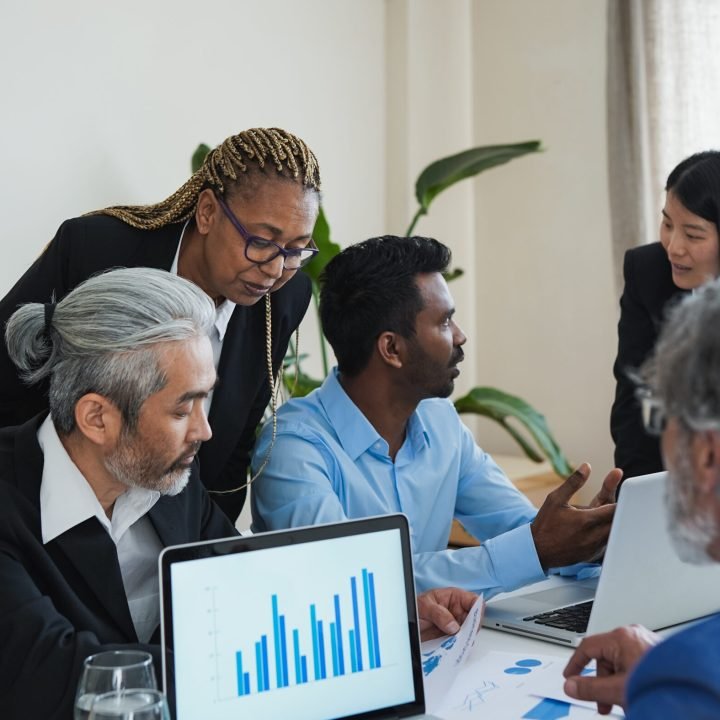 Multi generational people working together inside modern bank office