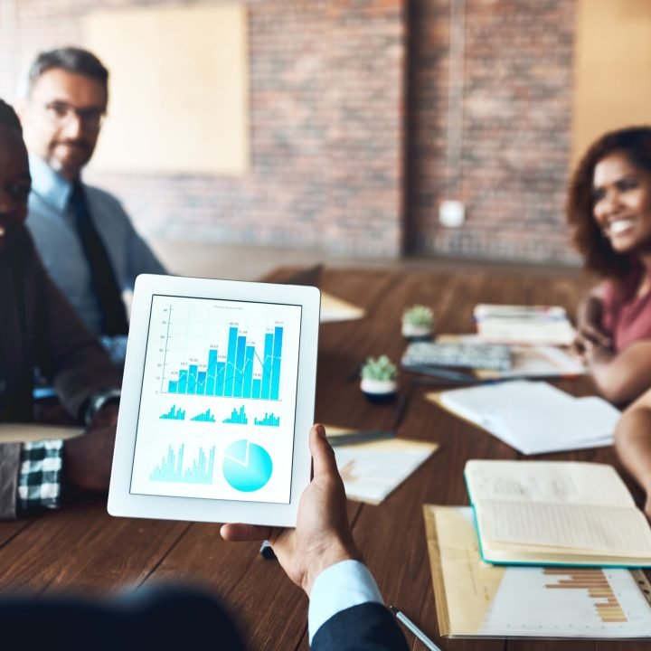 Shot of a group of businesspeople analyzing graphs in an office.